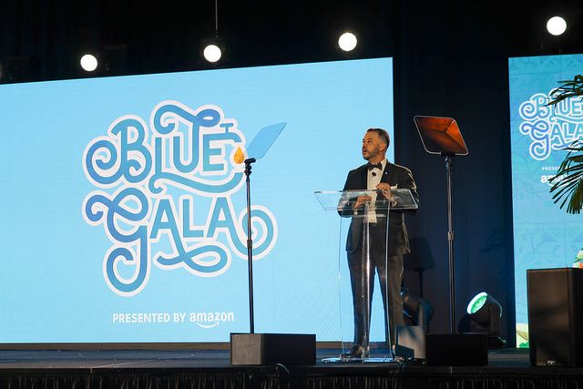 A BLUE Missions Gala speaker addressing guests from the main stage