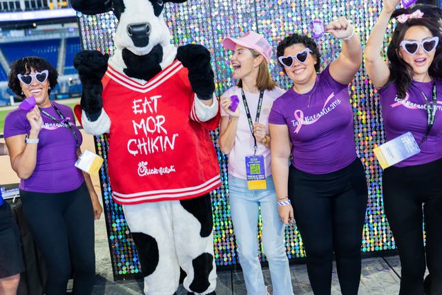 Give Miami Day participants celebrating with the Chick-fil-A cow mascot