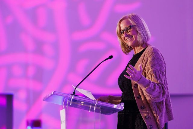 Keynote speaker addressing the Elevate audience from a clear podium
