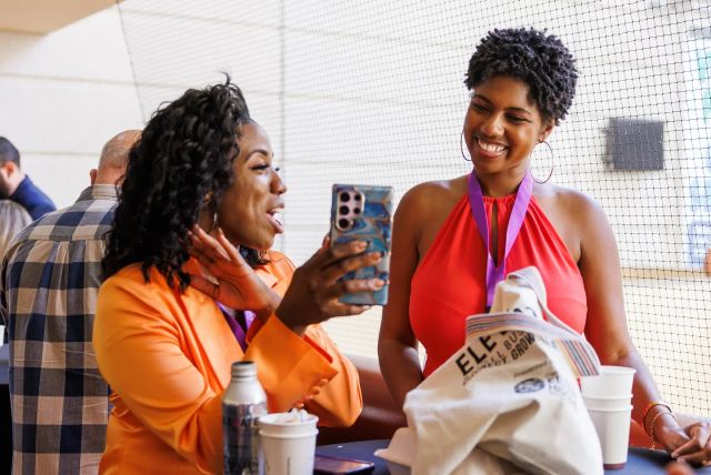 Two attendees smiling together during an Elevate networking session