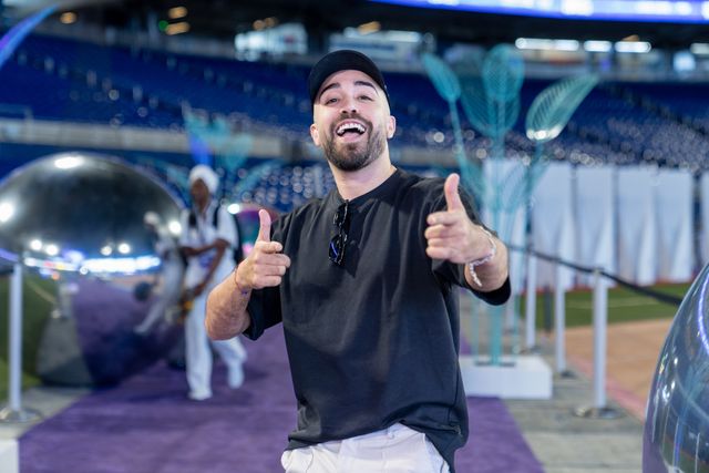 Give Miami Day guest smiling and giving two thumbs-up