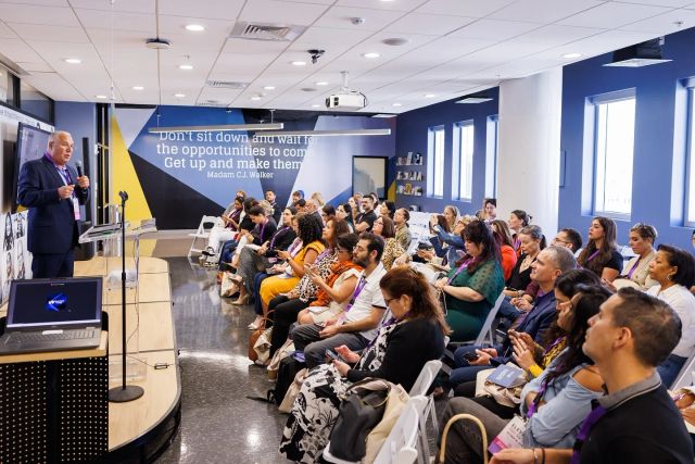 A full audience listening to a speaker during an Elevate educational session