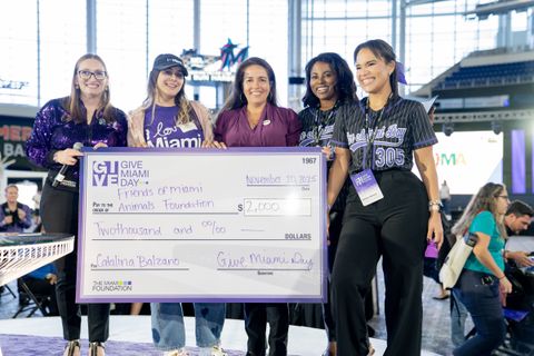 Five women holding a Give Miami Day grant check for the Friends of Miami Animals Foundation