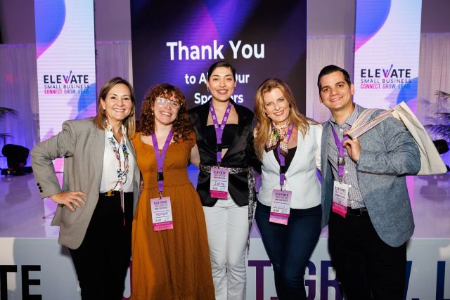 Five Elevate speakers posing together in front of the main stage