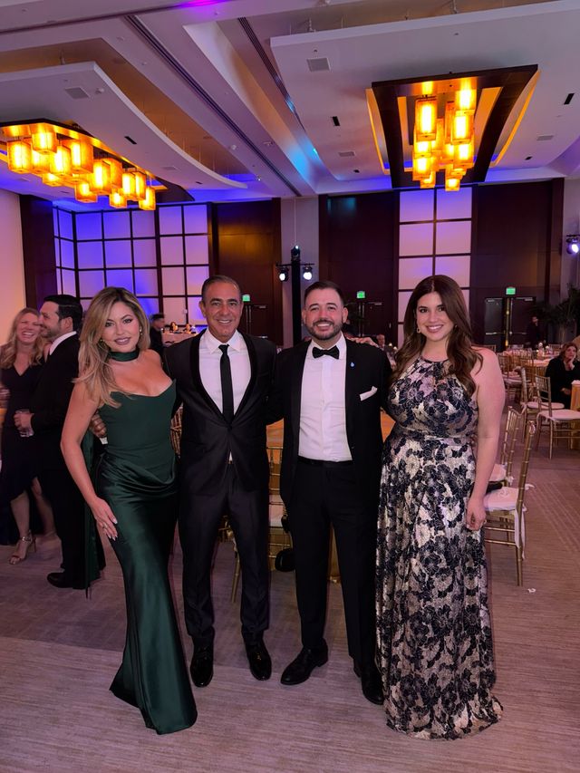 Four BLUE Missions Gala guests posing together in the ballroom