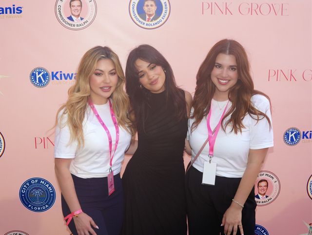 Camila Cabello posing with two women at the Pink Grove step-and-repeat