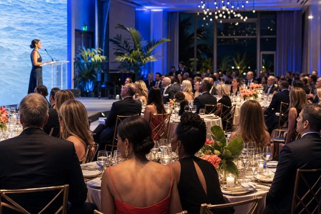 A BLUE Missions Gala speaker addressing a ballroom filled with guests