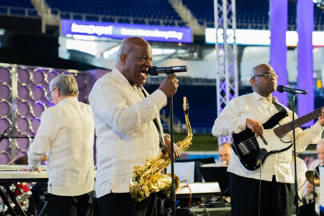 Spirit of Goodwill Band singer and saxophonist performing with the bassist